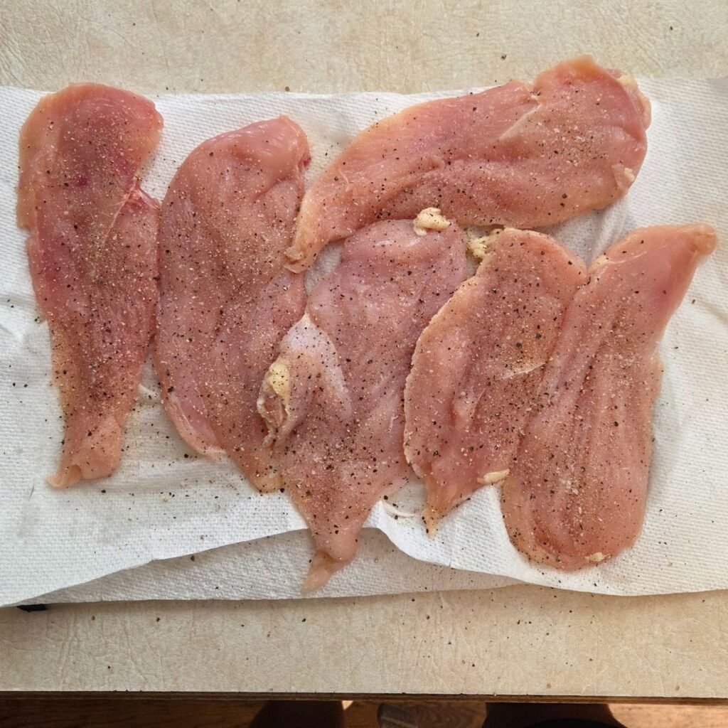Cut chicken breasts seasoned with salt, black pepper, onion powder and garlic powder