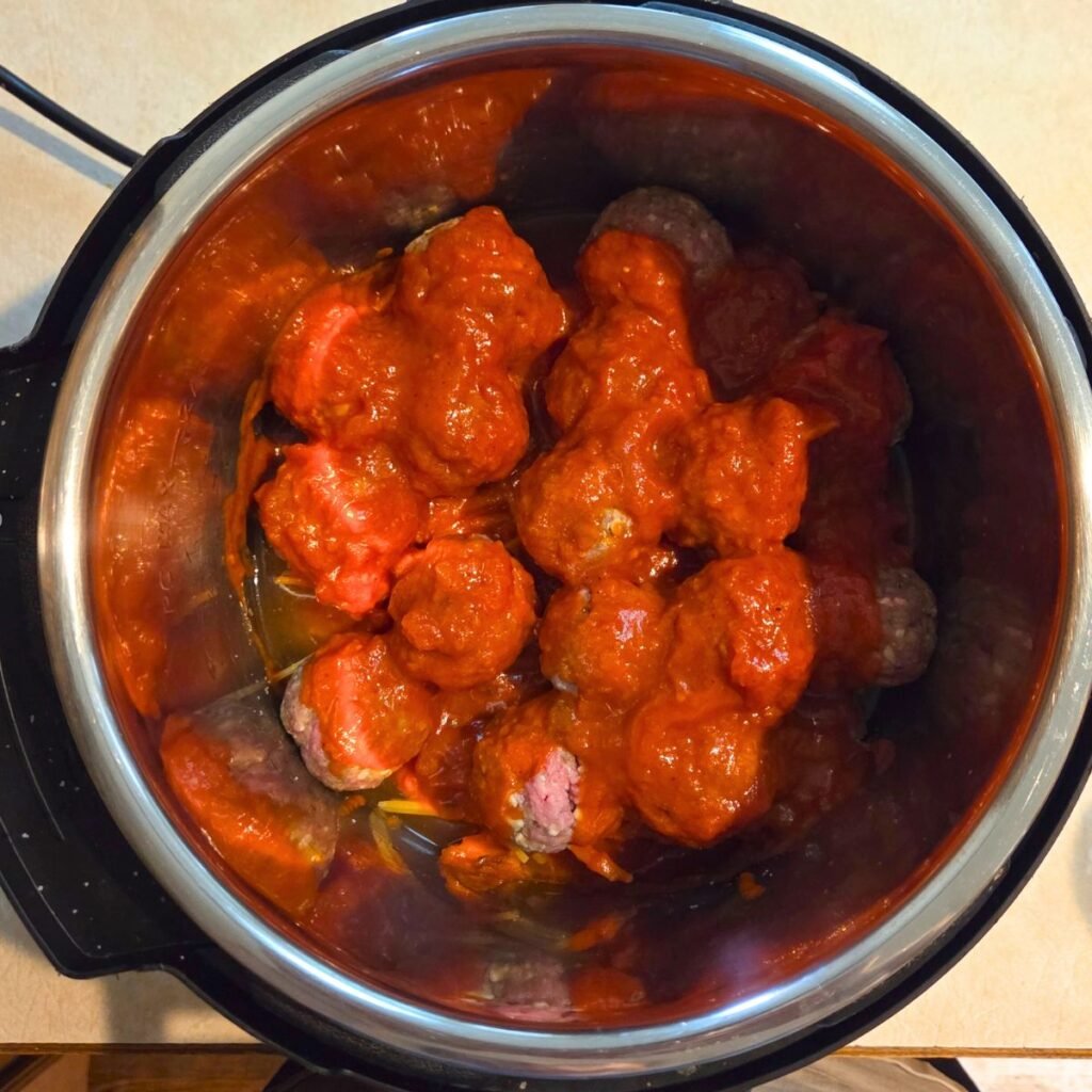 Sauce added to the top of the meatballs in the instant pot.
