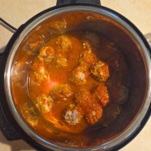 Instant pot filled with cooked spaghetti and meatballs.