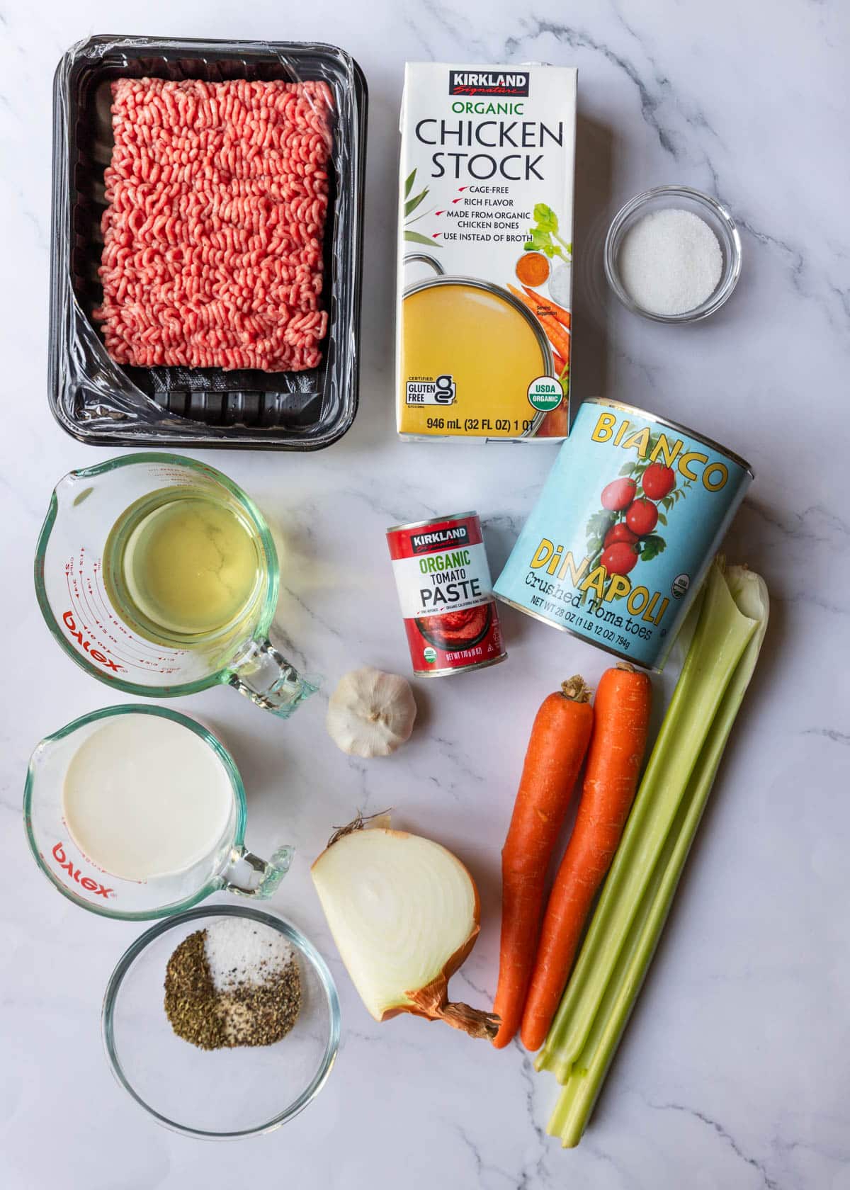 A table with ingredients for making Bolognese sauce