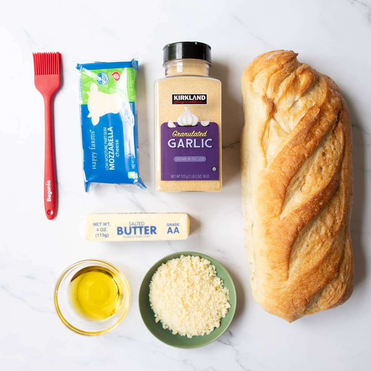 Ingredients shown are used to prepare cheesy garlic bread.