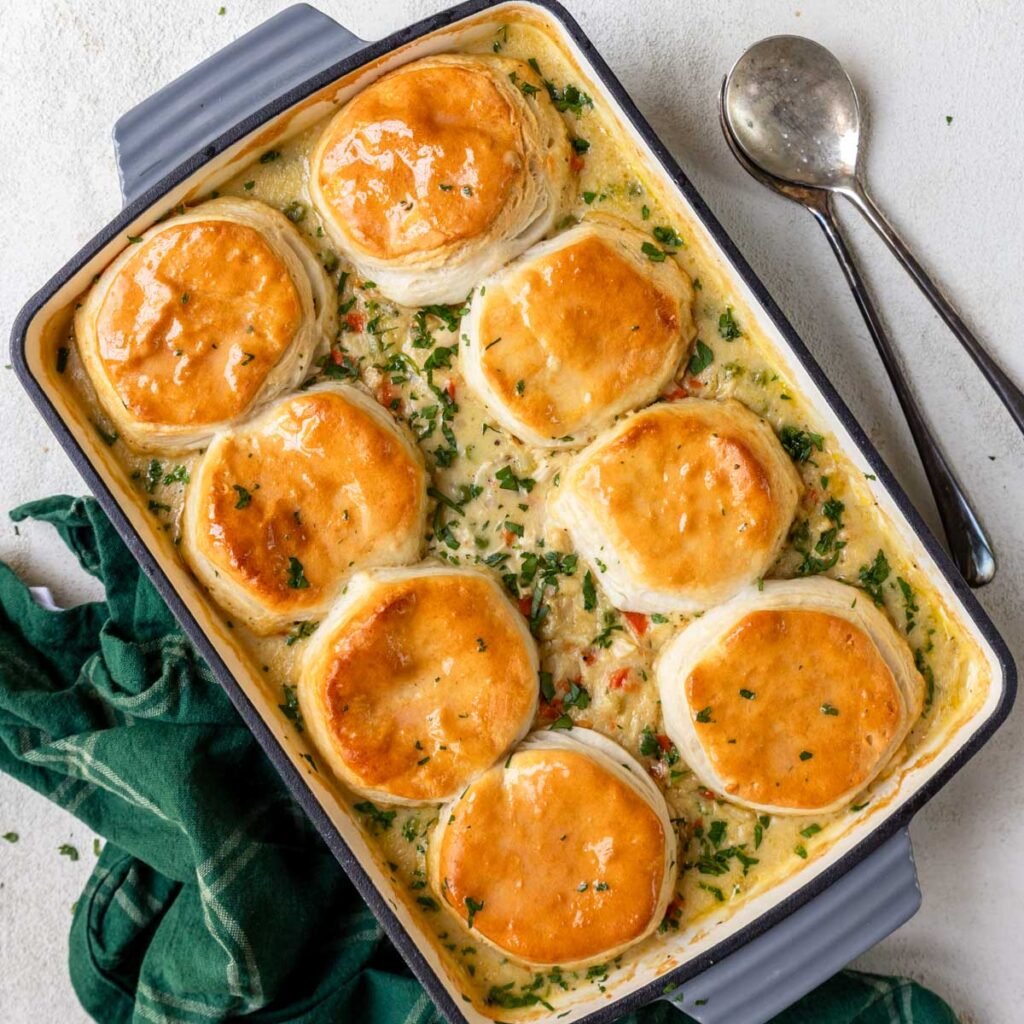 a 9x13 casserole pan with chicken and biscuits