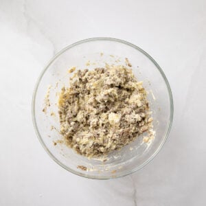 Cheese mixture in a glass bowl for manicotti stuffing.