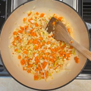 Diced onions, carrots and celery sauteeing in a Dutch Oven.
