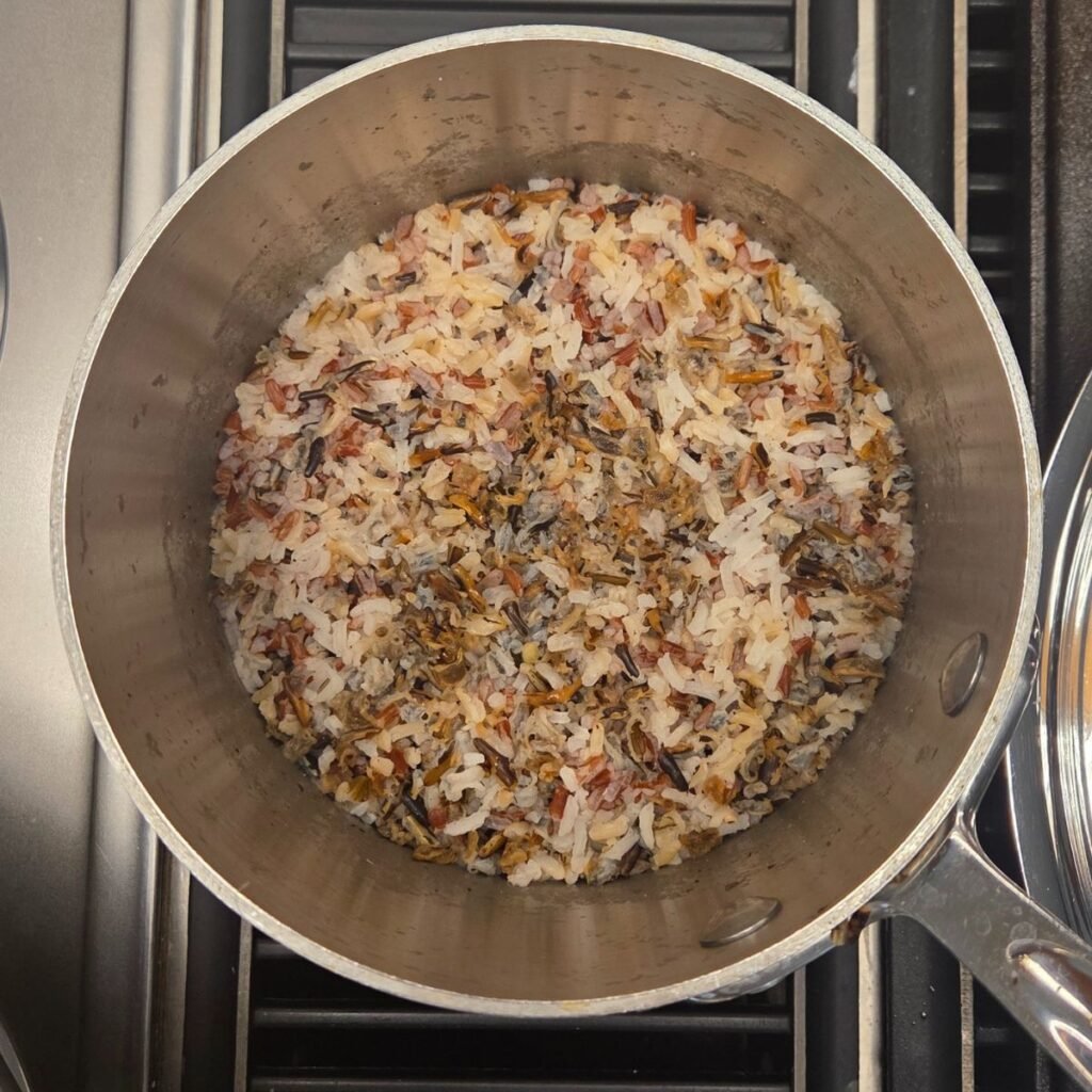 Cooked wild rice in a saucepan.