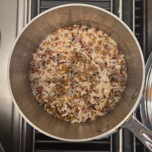 Cooked wild rice in a saucepan.