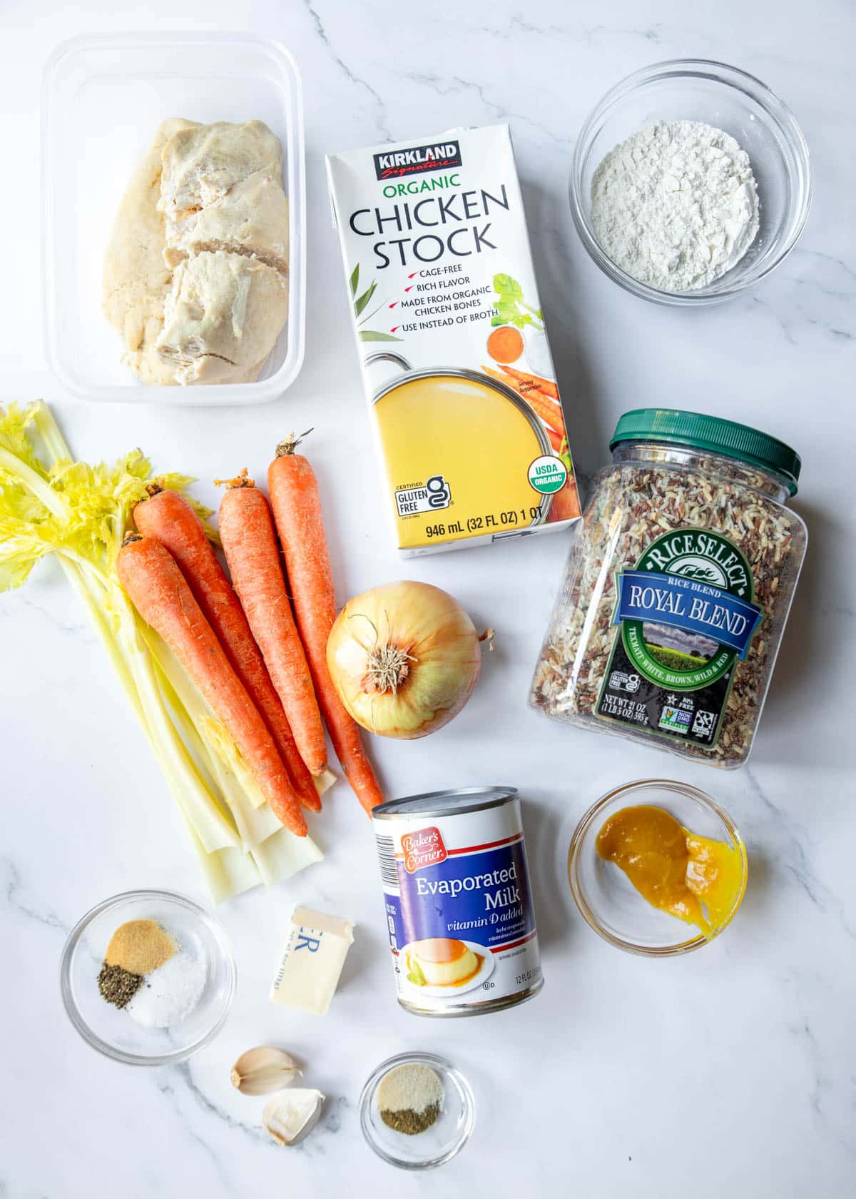 Ingredient shot with all the ingredients for chicken wild rice soup laid out in measured containers.