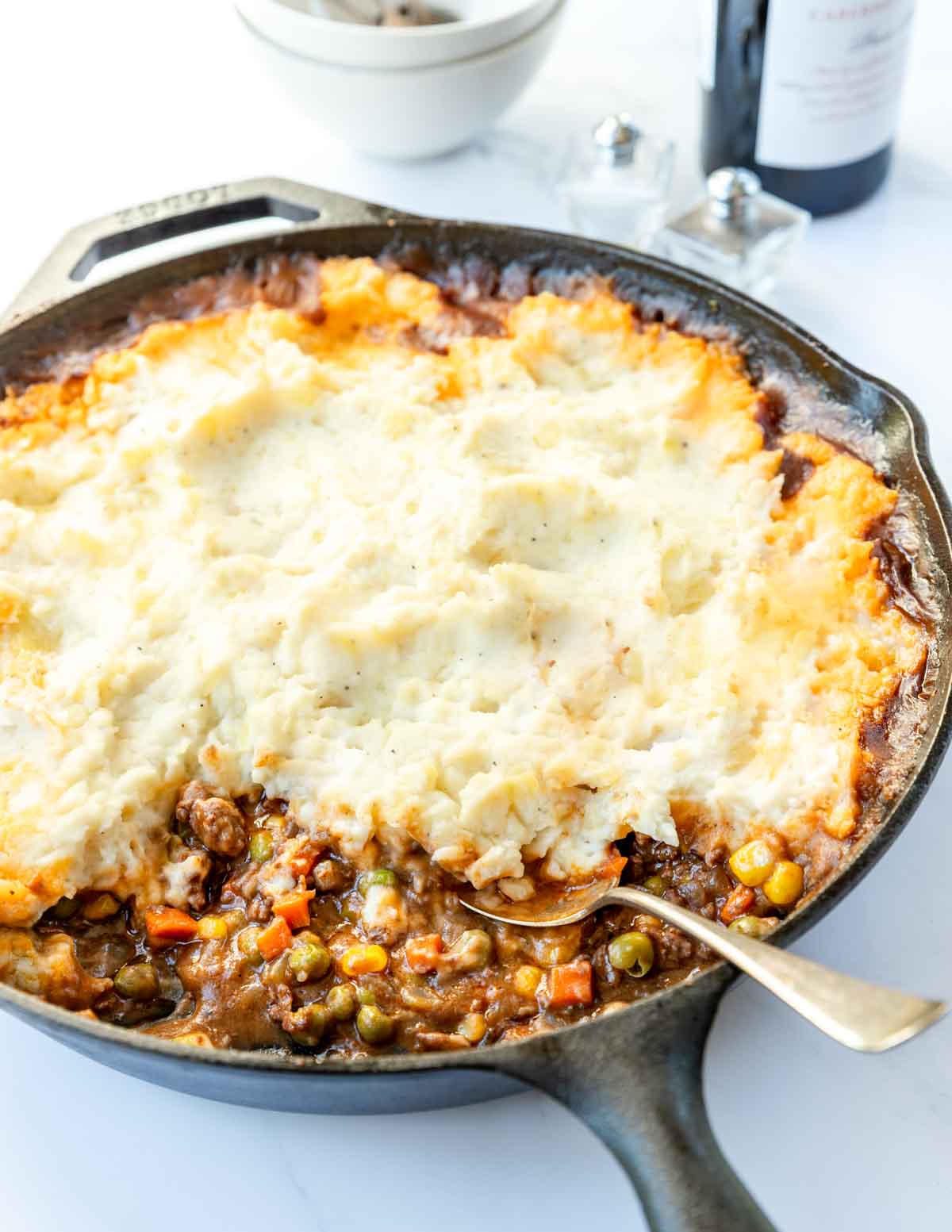 Large skillet with mashed potatoes topping a ground beef and veggie mixture.