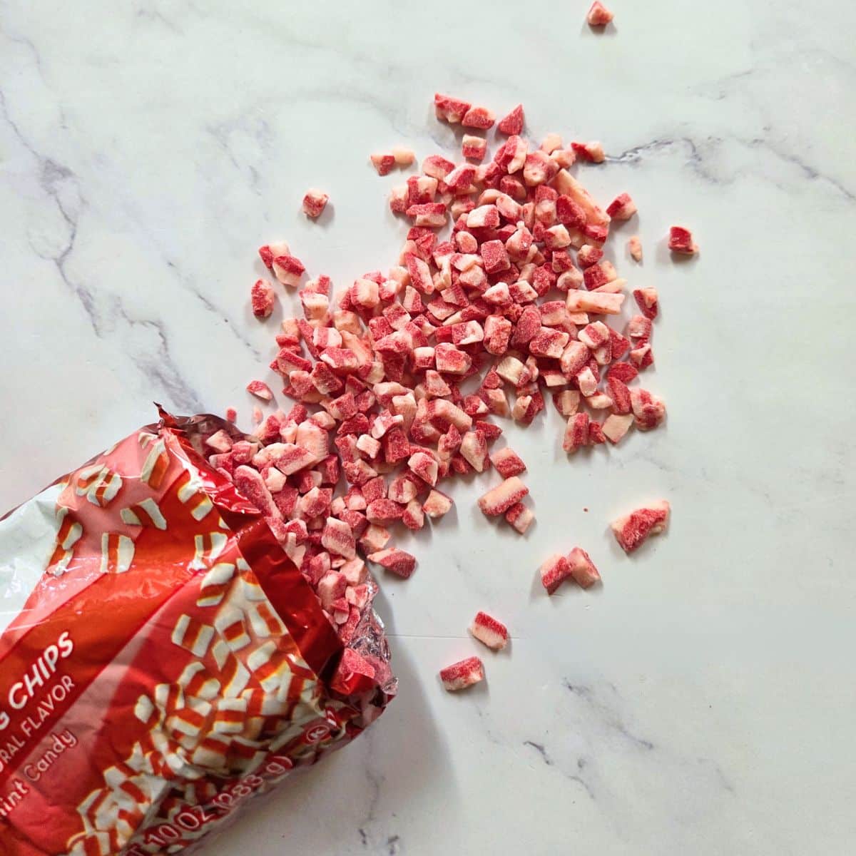 Peppermint pieces falling out of a bag.