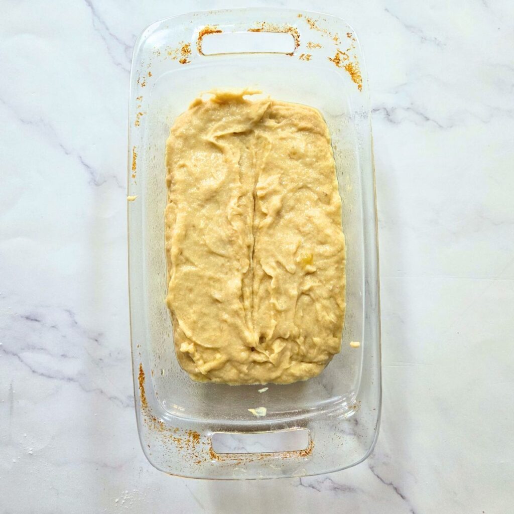 Banana bread batter in a loaf pan.