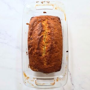 Freshly baked banana bread in a loaf pan.