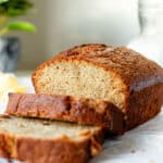 Thick slices of banana bread cut away from the loaf.