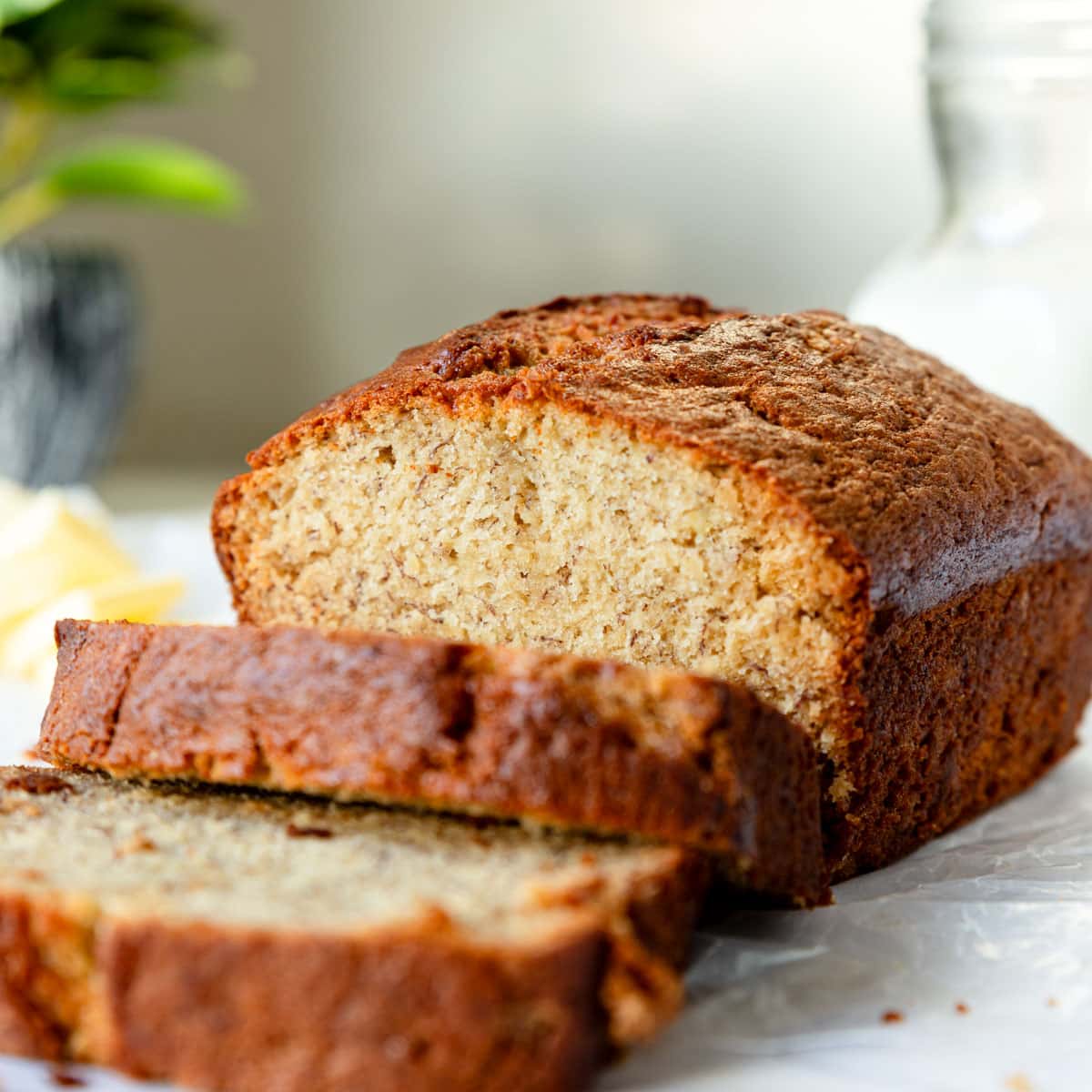 Thick slices of banana bread cut away from the loaf.