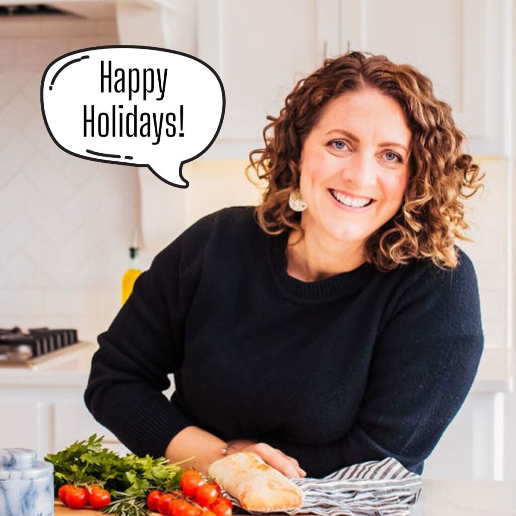 A picture of Susie Weinrich in the kitchen with a talking bubble that says Happy Holidays