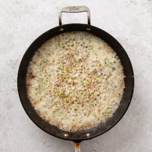 Chicken stock added to the mushroom mixture in a skillet.