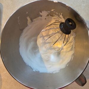 Whipped cream in a Kitchenaid mixer.