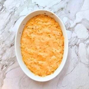 Just baked buffalo chicken dip in an oval serving dish.
