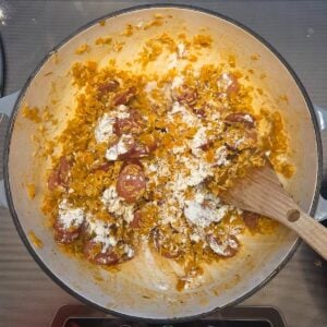 Flour being stirred into the veggie rice mixture.