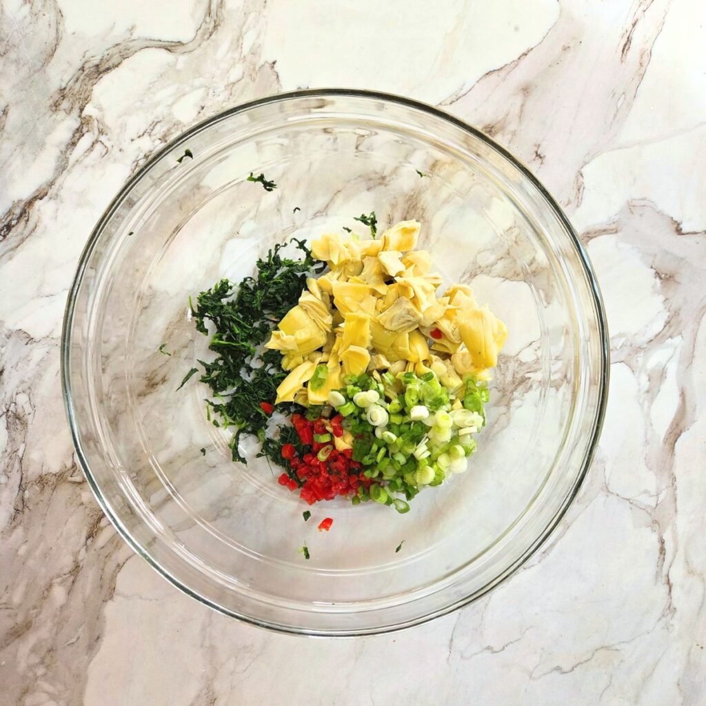 ingredients for SPinach Artichoke Dip in a bowl before it is mixed