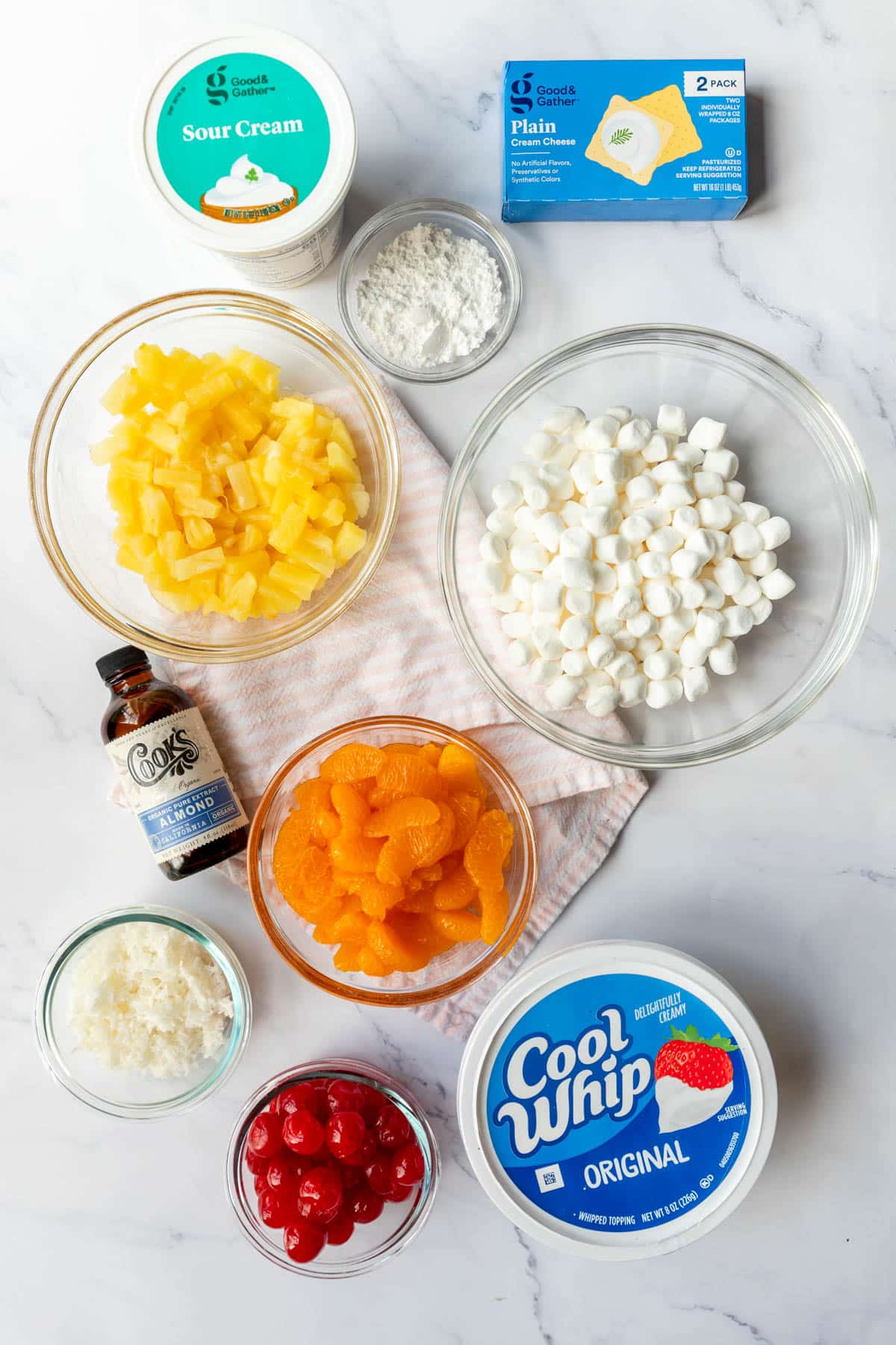 Ingredients laid out to prepare a classic Fruit Ambrosia salad.