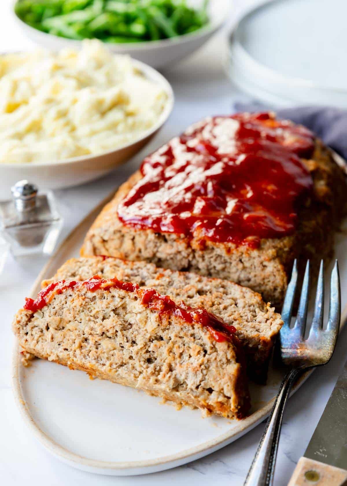 Ground turkey on a serving tray, cut into thick slices.
