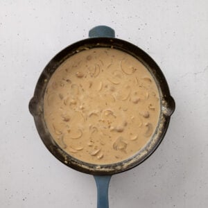Stroganoff sauce with mushrooms and onions in a skillet.