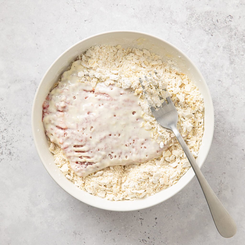 Marinated cube steak added to a mixture of seasoned crushed saltines.