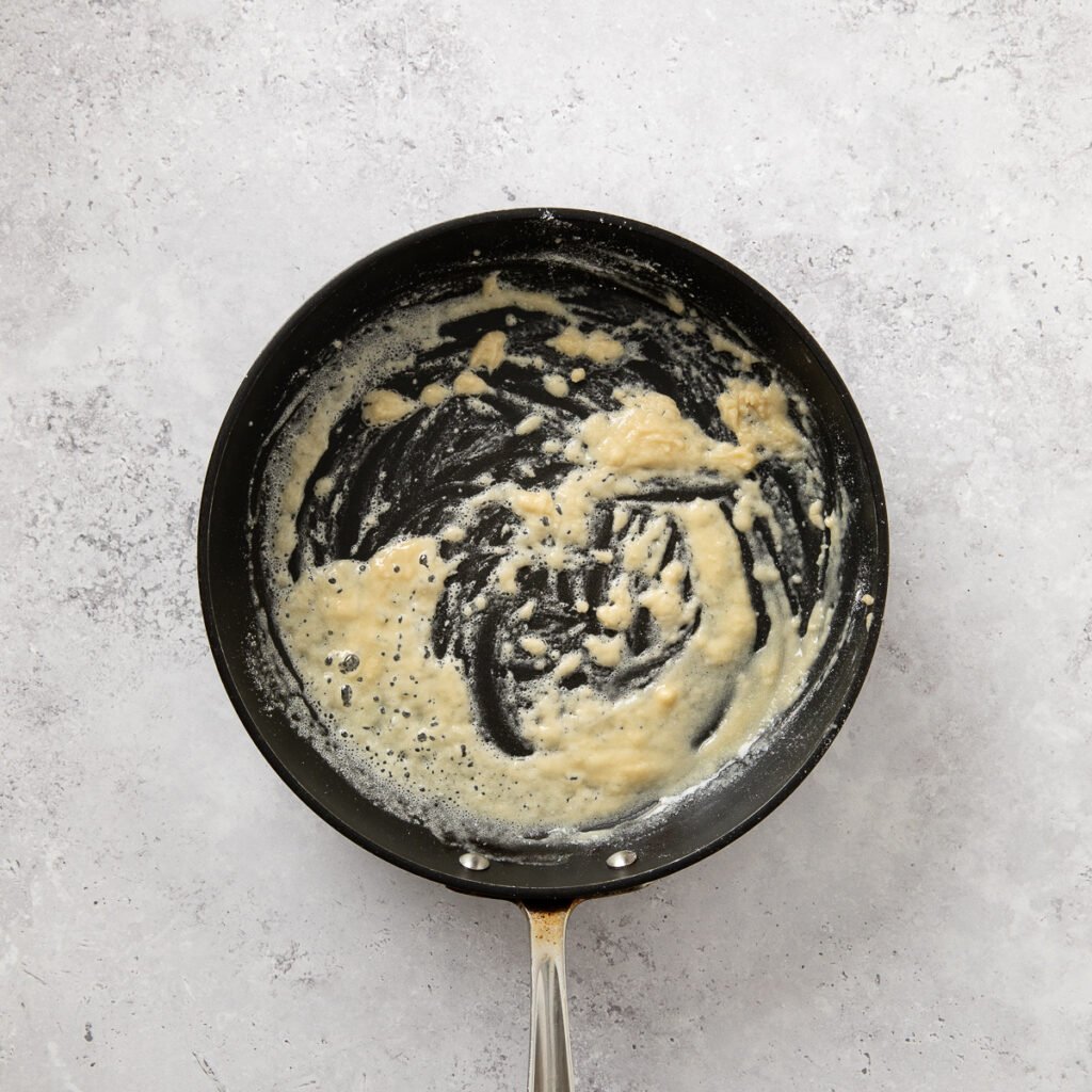 Roux being prepared in a skillet for country fried steak.