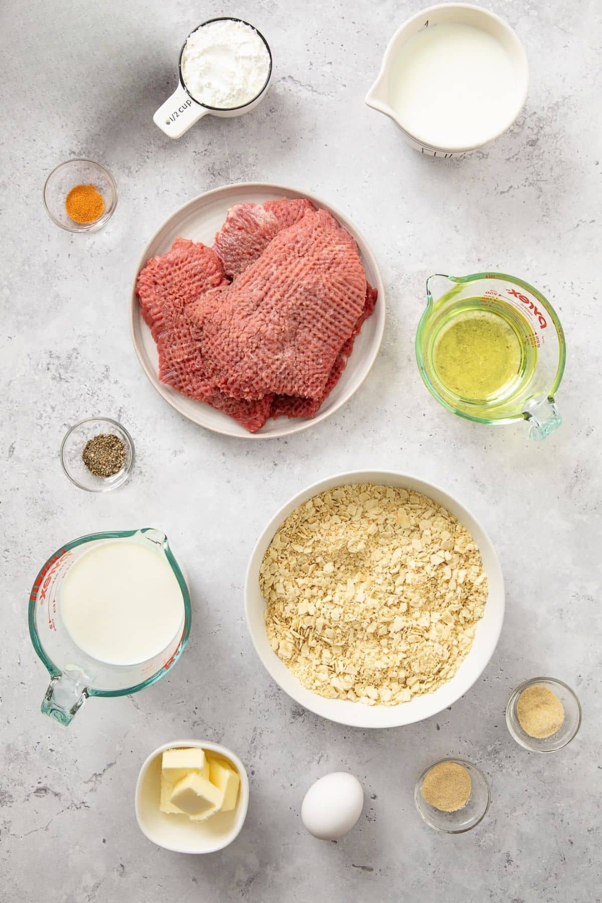 Ingredients shown measured out used to prepare country fried steak.