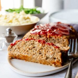 Close up of baked ground turkey meatloaf slices, served on a tray.