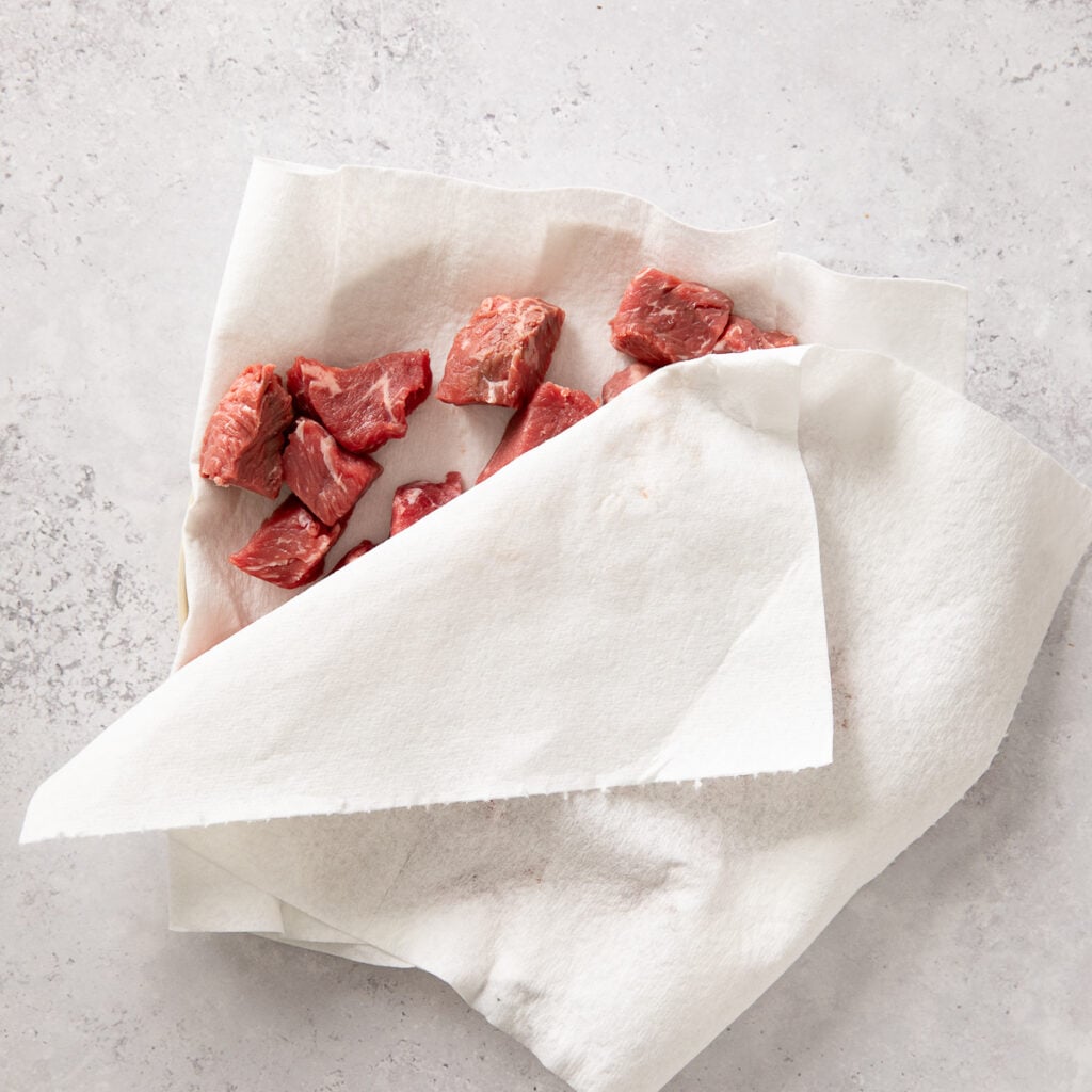 sirloin chunks in paper towels being dried