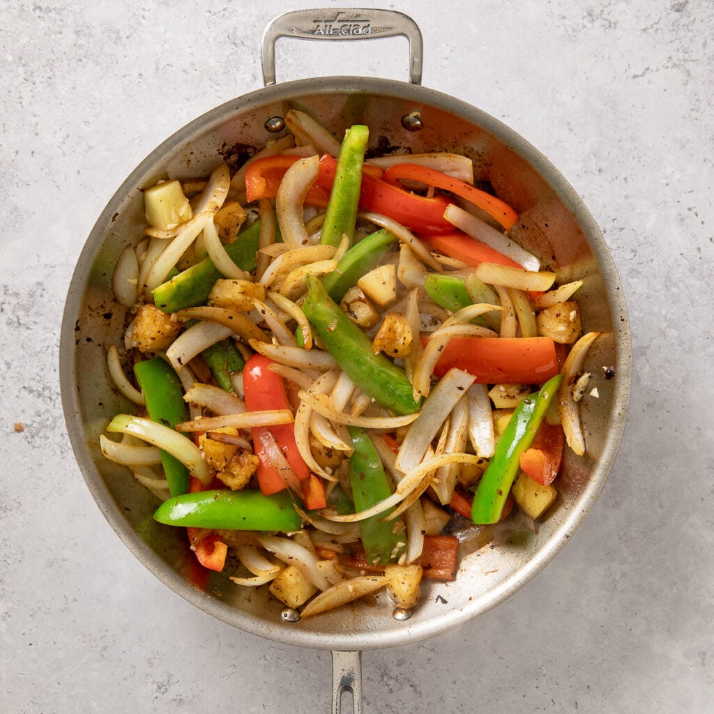 veggies and pineapple in a skillet for sweet and sour beef