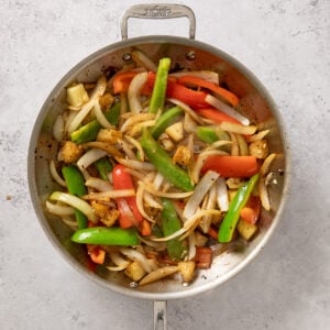 veggies and pineapple in a skillet for sweet and sour beef