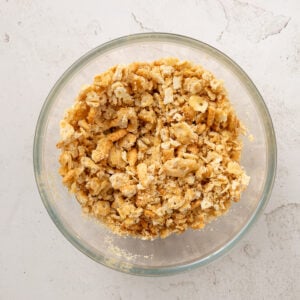 Crushed ritz crackers in a glass bowl.