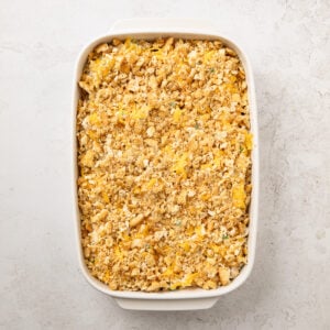 Buttery ritz cracker topping over tuna noodle casserole in a baking dish.
