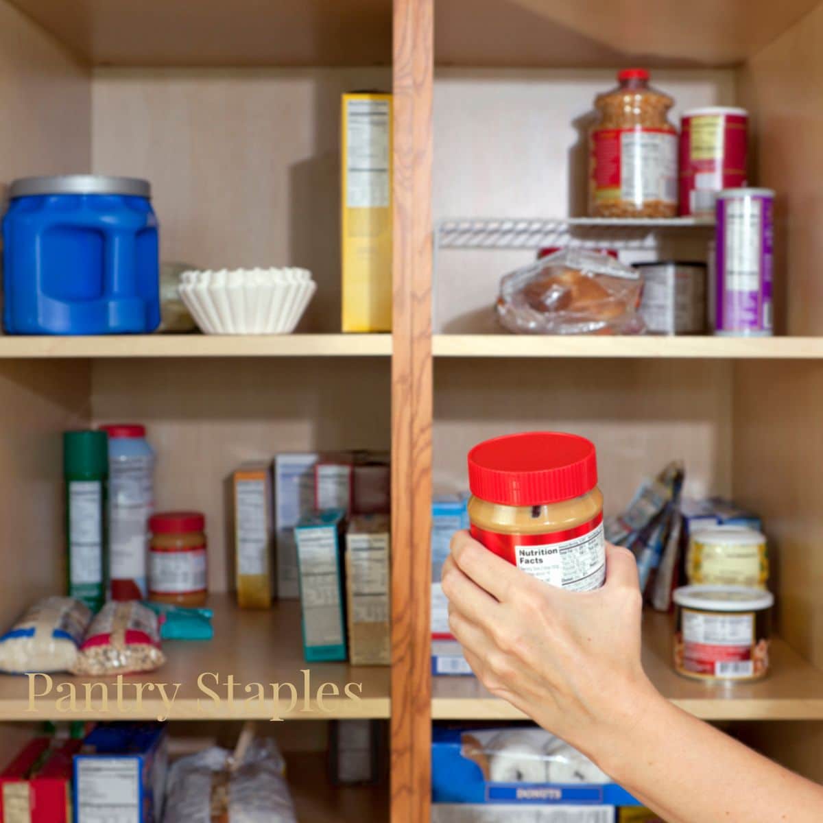 a hand putting peanut butter into the pantry or cabinet 