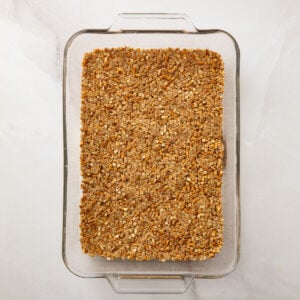Pretzel crust in a glass baking pan.